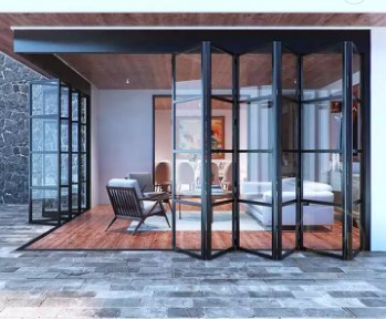 Black aluminum bifold patio door fully opened to an outdoor living area