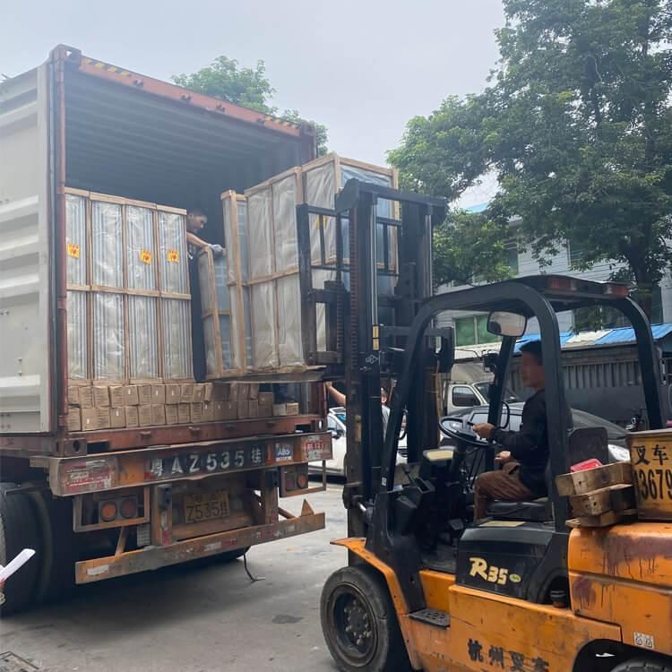 Forklift loading window crates into container